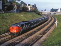 Toronto - Hamilton commuter 923 rounds the curve near <a href=https://www.railpictures.ca/?attachment_id=55132>Exhibition Station,</a> about to pass under Dunn Avenue.  Note the "Railway Junction One Mile" sign in place for the <a href=http://www.trainweb.org/oldtimetrains/CPR_Toronto/wharf_lead.htm>CPR Wharf Lead</a> just west of Strachan Avenue.

<br><br><i>Scan and editing by Jacob Patterson.</i>