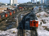 Lots of power is seen outside Spadina Roundhouse, including a set of three RDCs, led by CN 6208, GP9s at far right, a pair of GP38/40Ws with a B unit, an ONR 1801, Tempo RS18m, and an assortment of switchers, consisting of: CN 8520, 1240, 1243, 1241, 1257, 1247, 8225, 1252, 1258.

<br><br><i>Scan and editing by Jacob Patterson.</i>