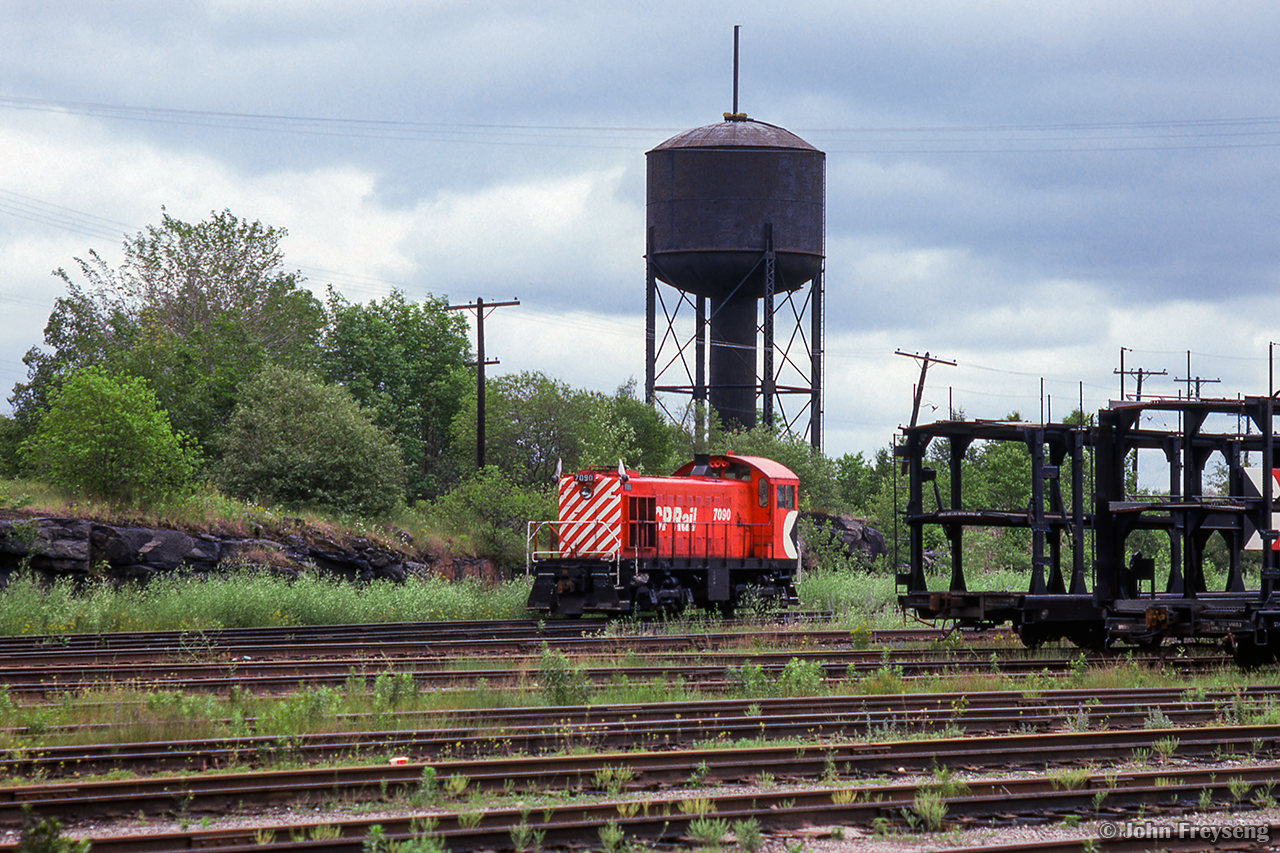 CP MLW S2 7090 sits in the yard at Mactier beneath the water tank.

Scan and editing by Jacob Patterson.