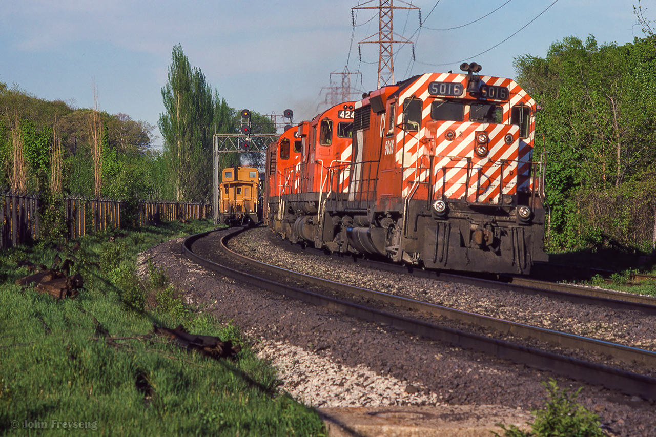 CP 5016 leads a pair of 4200s westbound through Summerhill, while an eastbound switcher and van prepare to knock down the light.

<Scan and editing by Jacob Patterson.