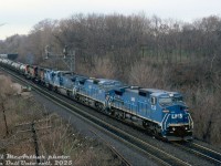 LMS C40-8M's 733, 715 and 722 lead EMD leaser 806 and CN GP40-2LW's 9401 & 9605 on CN train #362 through Bayview Junction on a gloomy day in April 1995.<br><br>The LMS 700-series units were part of a group built specifically for a Locomotive Management Services joint lease arrangement between GE, Conrail and CN, apparently spending half the year on CR and CN. After the Conrail split many became NS and CSX units, but a small group of 700's were leased to CN long-term and relettered as IC 2450-series units (the "Blue Devils" as they were sometimes known). The lease was later bought out by CN, and they operated in service until retirement in the early 2020's.<br><br><i>Bill McArthur photo, Dan Dell'Unto collection slide.</i>