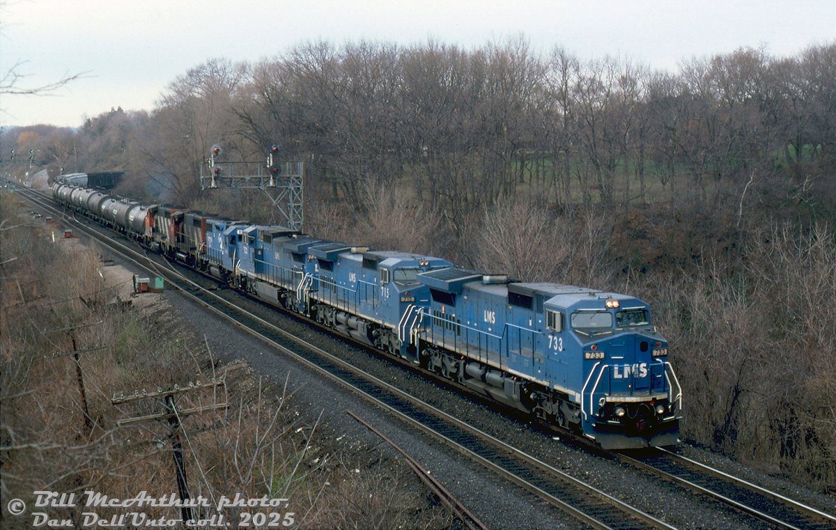 LMS C40-8M's 733, 715 and 722 lead EMD leaser 806 and CN GP40-2WL's 9401 & 9605 on CN train #362 through Bayview Junction on a gloomy day in April 1995.

The LMS 700-series units are part of a group built specifically for a Locomotive Management Services joint lease arrangement between GE, Conrail and CN, apparently spending half the year on CR and CN. After the Conrail split many became NS and CSX units, but a small group of 700's were leased to CN long-term and relettered as IC 2450-series units (the "Blue Devils" as they were sometimes known). The lease was later bought out by CN, and they operated in service until retirement in the early 2020's.

Bill McArthur photo, Dan Dell'Unto collection slide.