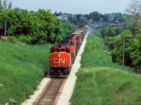 With brake shoe smoke trailing behind, CN Extra 9520 West rolls into Guelph just west of mile 48.

<br><br><i>Richard M. Panek Photo, Jacob Patterson Collection Slide.</i>