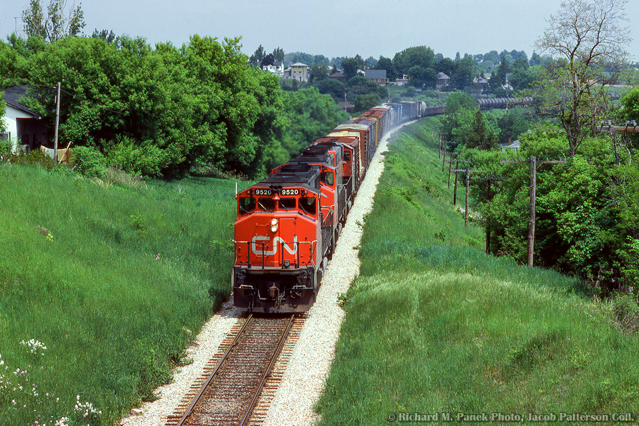 With brake shoe smoke trailing behind, CN Extra 9520 West rolls into Guelph just west of mile 48.

Richard M. Panek Photo, Jacob Patterson Collection Slide.