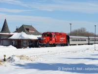 After a fire destroyed the <a href=http://www.railpictures.ca/?attachment_id=18795 target=_blank>Orangeville Bunkhouse</a> according to those in the know (Mr. Bradley et al) insurance settlement allowed the town to re-build a new structure in Orangeville. So they built a sorta replica of the Orangeville Station on the station site, complete with a witch hat. The actual CPR station still survives and was moved off property to become a restaurant, but for about a decade this replica building was alive with rail service - complete with a waiting room and washrooms for Credit Valley Explorer patrons. What a great station and a shame the town decided enough with railways. Alas, it is still a nice looking station just no rails at present time, and now used as  a GO bus station. Pictured 12 years ago is the "Snow Train" with a briefly loaned brand new Eco on the point pulling into the station after completing the last run of the weekend. This would be last passenger train until that spring.