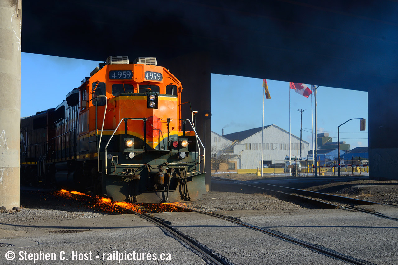 When these things were patched a year ago, Jacob and I decided to head to Hamilton to see if it was out and about - sure enough, it was, and after following them for a little bit we realized they'd run-around and shove into Railcare with this thing leading in nice light. Matthew Ettorre was also out and had the same idea, so the three of us watched them shove into the railcare yard with a cut of cars, only to slow to a crawl, and notch up into 8 under the bridge - with a sound and smoke show to match multiplied by the bridge blasting it all right back down at us - naturally we're smiling at the smells and sounds before us, then it got better -  sparks began flying as they stalled. I didn't think sound and smoke would get any better, but it did - a feast for the eyes. The crew didn't take long to realize what happened and were able to recover and shove into the yard without much issue. I know the Hamilton crews watch this site - I hope they see this :) 

A footnote is I'm told this unit was painted recently - why is CN in such a hurry to paint the BNSF four axle locomotives they purchased but seemingly nothing else in the series? Any ideas? Seems strange.. if you know of any other repaints or have any other ideas please comment below.