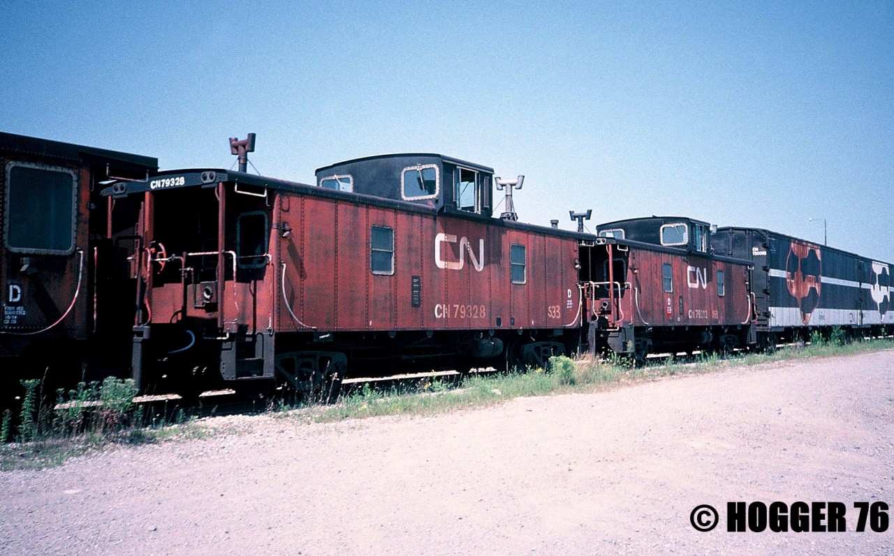 Retired CN Hawker Siddeley cabooses 79728, 79328 and 79212 are shown awaiting their fates at the S Yard at CN’s MacMillan Yard in Vaughan, Ontario. Also seen behind the vans were two retired Car-Go-Rail cars that were used in Super Continental passenger service.