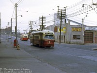 Passing through the somewhat run-down West Donlands/Corktown area of the city, TTC PCC 4379 (A6-class, CC&F 1947-48) heads westbound on King Street East at St. Lawrence Street, after passing another King PCC (46xx A11-class) on its way east to the Don River bridge in the distance (note the <a href=http://www.railpictures.ca/?attachment_id=56312><b>Coleman building</b></a>). On the right is Central Body & Fender (align with Bear to stop the shimmy!) and S. McCord's cement plant along Bayview Avenue hiding behind one of the obtrusive utility poles.  Today, gentrified office buildings and condos have replaced much of the old factories and shops in this gritty scene.
<br><br>
<i>Joe Testagrose photo, Dan Dell'Unto collection slide.</i>