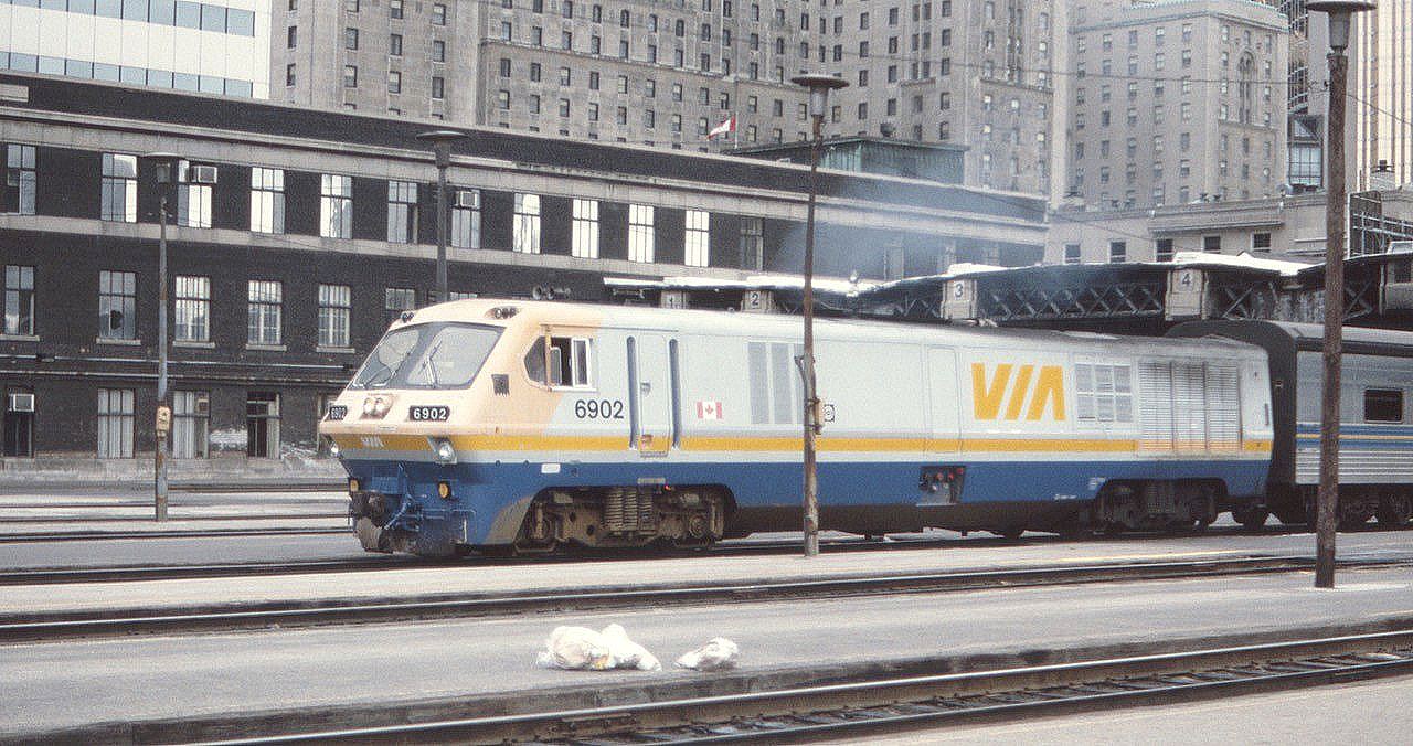 Via 6902 heads out of Toronto Union Station with a westbound train and cloud of smoke in August of 1984. This LRC-2 unit was built in 1980 and the internet reports it scrapped in 2007. What a wide variety of trains back then. The famous Royal York Hotel looms in the background.