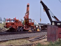 <br>
<br>
The 250 ton Toronto Auxiliary CP Rail 414501, built 1946 by Industrial Brownhoist is cleaning up,
<br>
<br>
along with hi rail wrecking crane CP Rail  414052, built by Pettibone, that appears to be in primer paint.
<br>
<br>
A third truck mounted crane is working beyond the CP Rail forestry products box car (in green). 
<br>
<br>
At CP Rail Don Mills crossovers mile 204.1 Belleville Sub., July 1987 Kodachrome by S.Danko
<br>
<br>
 