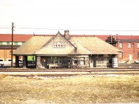 Such the impressive structure.  It soldiers on to this day as the Mettawas Station Mediterranean Restaurant. (No, I have not tried it) Once the station was declared expendable after the railway ceased operations thru here, it sat vacant. A determined effort by the locals saved it.
The station that once served Lake Erie, Essex and Detroit River Railway was built in 1889, solely of local fieldstone and timber, by Hiram Walker. Business was brisk since he also had a hotel and casino down by the lakefront.
Once upon a time this busy main line location had a yard, water tank, freight office and spur lines to various industries that located close by. They included grain facilities, fruit storage and especially tobacco businesses.  I believe that was a tobacco establishment you can see behind the station. I do know it is now the site of many new homes...... (note MoW car behind station)
The rail line is gone and the Chrysler Greenway trail corridor opened on the site in 1997.