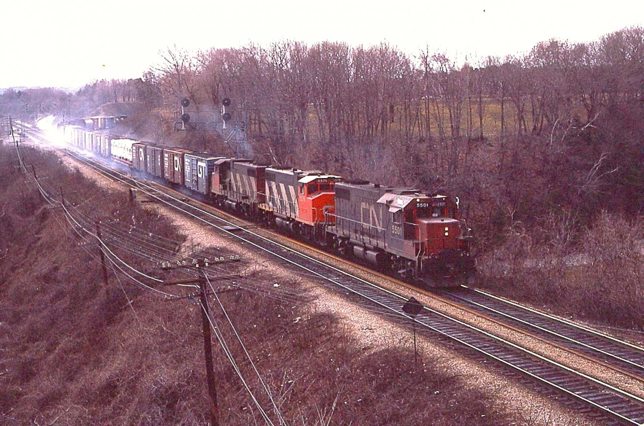 In the days before dynamics, we often saw clouds of "smoke" as the regular braking worked hard slowing up the train after the long 9 mile downhill grade from Copetown.  Here, it is rather obvious on this eastbound led by CN 5501, 5570 & one unidentified unit.  Colour me weird, but I loved the smells............