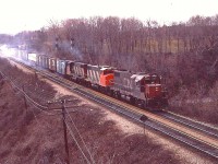 In the days before dynamics, we often saw clouds of "smoke" as the regular braking worked hard slowing up the train after the long 9 mile downhill grade from Copetown.  Here, it is rather obvious on this eastbound led by CN 5501, 5570 & one unidentified unit.  Colour me weird, but I loved the smells............