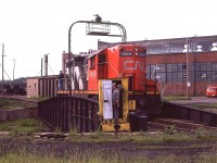 It has been a long time since I have witnessed the turning of power on the table. Here is CN 4589 going thru that very motion on the For Erie turntable which was to the south of the main shop building (background) and to the east of the roundhouse.
Always was some entertainment for the fans back in the day when CN had a sprawling yard and the capability to handle many heavy locomotive repairs.
All gone now.
