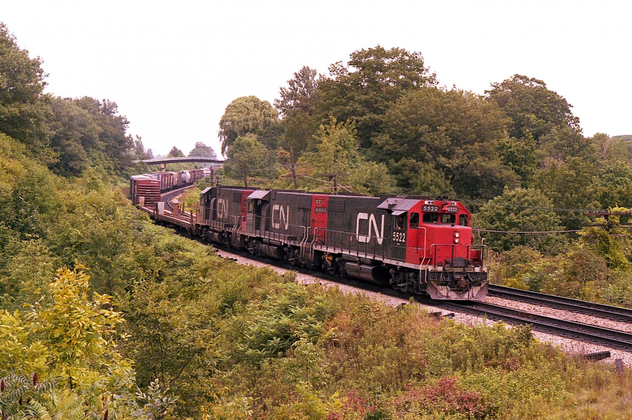 Back when I realized I was going to be stuck in this hobby of railroad photography, I always enjoyed seeing these GP38-2 units with their basic black paint and sleek sides; as in: No Blisters. They have been endless workhorses; from their birth in 1972-73; then rebuilt and renumbered to the 4700 series in 1988. They are still seen around the country working short runs and local jobs. 
It has been a long time since a trio looked as nice as these.  CN 5522, 5523 and 5516 heading west on approach to the junction.
