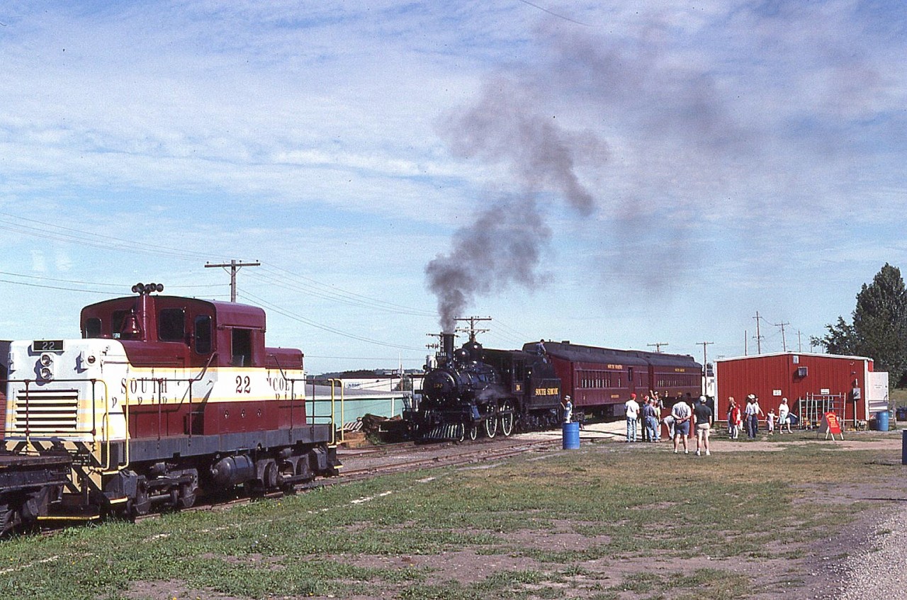 It is a nice pleasant Sunday morning, July 18, 1993 as South Simcoe Railway's historic 1883 steam engine #136  has pulled up to the station and is about to take on passengers for the 4 mile run. The building pictured is the only station. On the left is the former CP side-rod switcher, #22.
These days the #136, a 4-4-0, once the star of the National Dream TV series, is down for maintenance and will not likely be running in 2026. It will still be business as usual, running weekends from May to October this year via diesel. The run is from Tottenham to Beeton and return. In the Trackside Guide, you will find information listed under 'New Tecumseth', the regional name applied to the area.