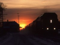  After a day of hunting snowplows near Stratford, a quick stop was made in Ingersoll probably for a coffee and a bite to eat before heading back towards the GTA. A stop by the station found the sun setting directly in line with the Dundas Sub and the headlight of VIA No 78 rapidly approaching. I'm guessing the exposure on this Kodachrome 64 slide was a fluke. Sometimes you take the shot and score. 
