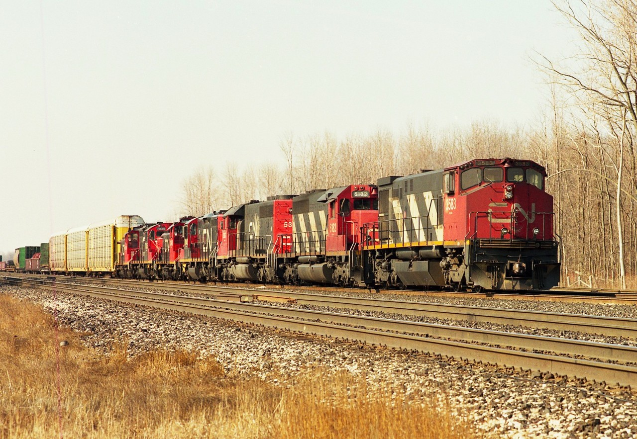 Quite the collection of locomotives on the head end of this eastbound working at Aldershot Yard. Of interest is the leader, CN 3583, a BBD product, model HR412(W). Built 1981. It didn't last long; going to Lake State RR in Michigan as their 698 and since been scrapped. Other units: 5182, 5367 (x-UP 4108), 7043, 1348, 7035 and 1396. Getting into the yard at the east end is not recommended any more.