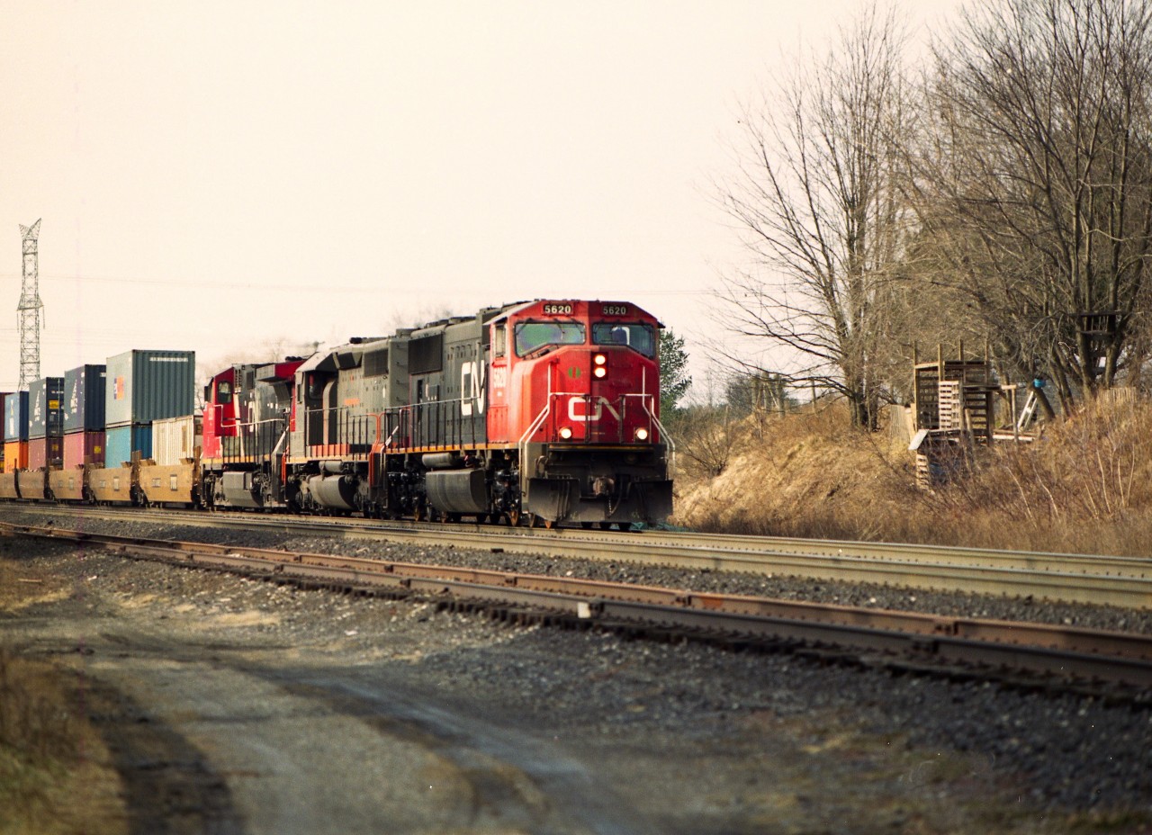Just a shot of eastbound  #148 with CN 5620, GCFX 6075 and CN 2521 rolling by the old mill structure at Copetown.
But look closer. The Southern US used to be famous for the Harvey House restaurant chain.  In Copetown, it was the nowhere near famous for anything, Hobo House.
Not sure of the story. It was said these guy(s) dug into the hillside and made a shelter, and it is obvious they got very creative and raided pallets from across the tracks to build their rather elaborate side split shelter. Each time I checked on this place (from a distance) it seemed to expand, until one day I showed up and it was gone.
Just a silly memory from Copetown.
I'm sure some others who frequented this area would have more to add, or to correct, this story.