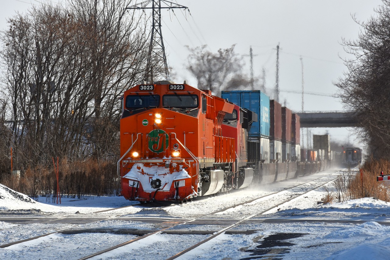 This is the result of a nasty bitter morning.  It was 3F and windy in Grimsby and it was a long wait at the Grimsby kiosk for CN 422 to make the scene. Apparently second unit (of two) had crapped out and the train was running about 22 MPH.
AMTK was very one hour late as well. It can be seen waiting at Nelles Rd where the two tracks become one, and when 422 clears it and 421, not far behind, can continue east.
Nice to see the "Flying J", which is why I bothered escaping the warm confines of home in the first place.
Power on train was CN 3023 and 3833.