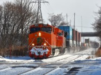  This is the result of a nasty bitter morning.  It was 3F and windy in Grimsby and it was a long wait at the Grimsby kiosk for CN 422 to make the scene. Apparently second unit (of two) had crapped out and the train was running about 22 MPH.
AMTK was very one hour late as well. It can be seen waiting at Nelles Rd where the two tracks become one, and when 422 clears it and 421, not far behind, can continue east.
Nice to see the "Flying J", which is why I bothered escaping the warm confines of home in the first place.
Power on train was CN 3023 and 3833.
