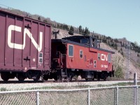 Just after arriving at Montmorency Falls, PQ, on a school trip, a westbound freight train passed the falls in May of 1982. CN caboose 79821 brought up the rear. I waited by the tracks for another train and did not go in to see the falls. Alas, I did not realize that this line, the Murray Bay Sub, was not a CN mainline. There is a tourist train there now - I should go back and see the falls. 