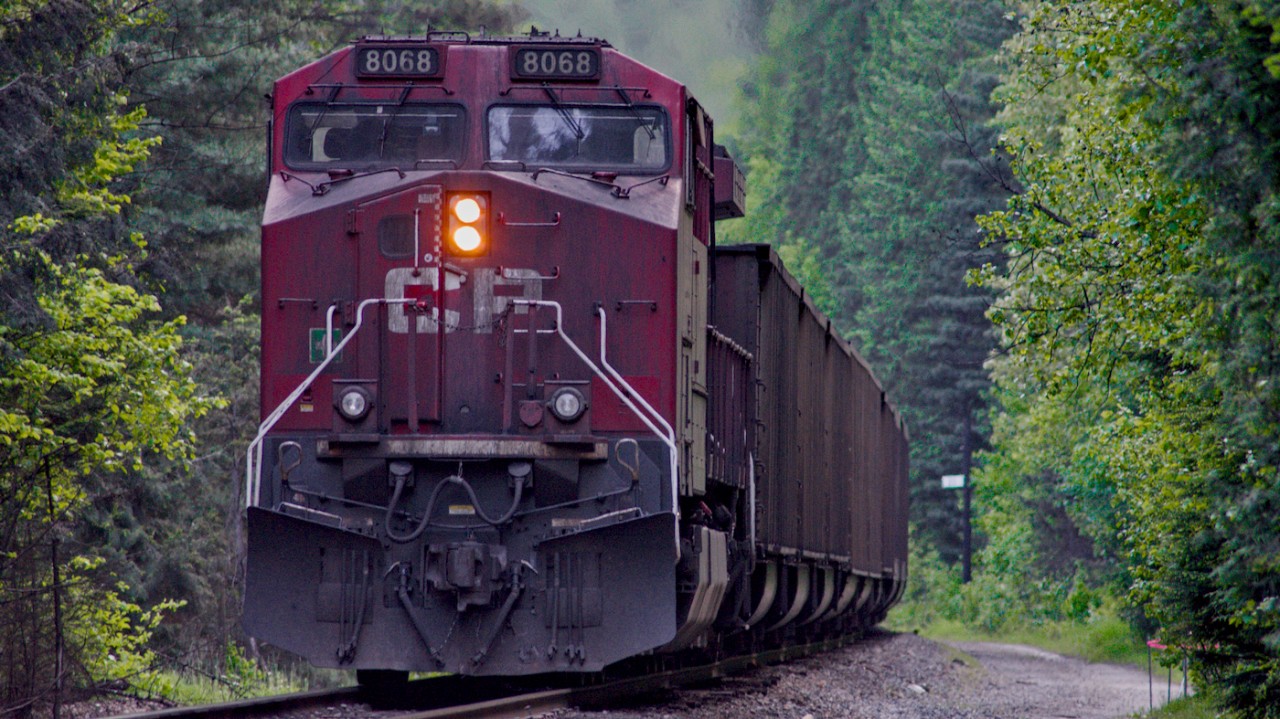 CP 8066, sporting a very dirty paint scheme, shoves a west bound coal train towards Revelstoke BC.