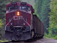 CP 8066, sporting a very dirty paint scheme, shoves a west bound coal train towards Revelstoke BC.