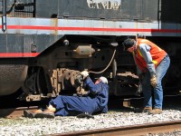 One for the "Human Element of Railroading": after a successful run down to Streetsville and back to interchange cars with Canadian Pacific, conductor Steve Bradley (in vest) and his engineer (in blue overalls, I believe his name was Wayne) change out some brake shoes on the lead Blomberg B truck of Orangeville-Brampton Railway's lone unit, CCGX GP9 1000, after putting her away on the station track. No fancy tools here, just pipe wrenches, hammers, and a bit of ol' fashioned manual labour to get the 1957-vintage unit ready for its next run.
<br><br>
(And thanks for the short cab ride, guys).