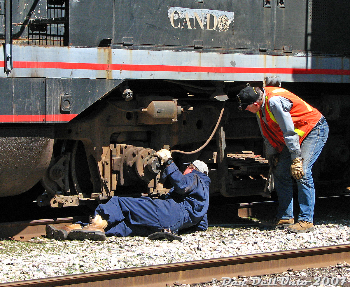 One for the "Human Element of Railroading": after a successful run down to Streetsville and back to interchange cars with Canadian Pacific, conductor Steve Bradley (in vest) and his engineer (in blue overalls, I believe his name was Wayne) change out some brake shoes on the lead Blomberg B truck of Orangeville-Brampton Railway's lone unit, CCGX GP9 1000, after putting her away on the station track. No fancy tools here, just pipe wrenches, hammers, and a bit of ol' fashioned manual labour to get the 1957-vintage unit ready for its next run.

(And thanks for the short cab ride, guys).