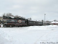 Orangeville-Brampton Railway's GP9 CCGX 1000 sits in her usual parking spot on the station track, coupled to the usual Credit Valley Explorer passenger cars as they sit idle on a quiet winter's morning in Orangeville. There was hopes that the usual freight would run today (Wednesday) because of all the recent snowfall, but they had in fact cleared the yard and run the previous day (Tuesday), as usual. There was little happening in Orangeville, but a few shots were taken of the train and its new station (with its new GO Transit shelter added, used by the Orangeville GO bus, that I also met and shot enroute during the trip back south to Brampton).<br><br>And today, there's even less happening down at the station in Orangeville...that GO bus is about the only kind of passenger service they'll see for a loooong time (and even that's not safe from the occasional GO low ridership cuts).