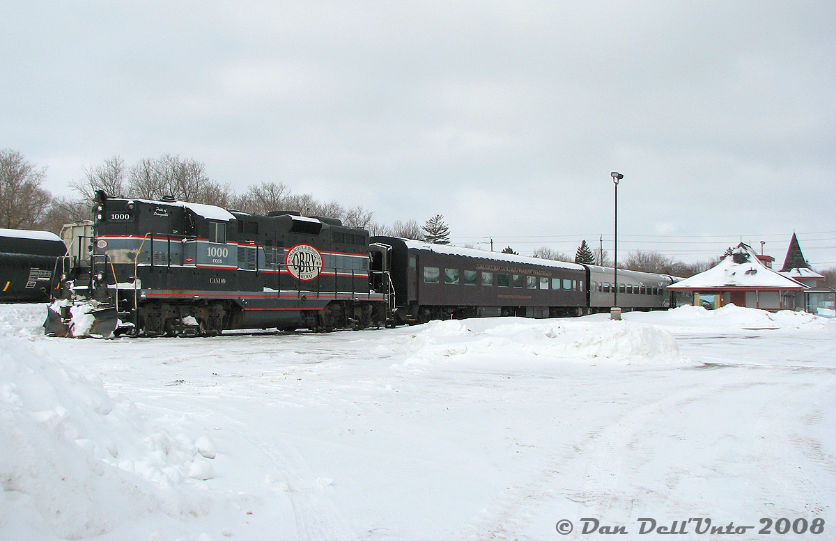 Orangeville-Brampton Railway's GP9 CCGX 1000 sits in her usual parking spot on the station track, coupled to the usual Credit Valley Explorer passenger cars as they sit idle on a quiet winter's morning in Orangeville. There was hopes that the usual freight would run today (Wednesday) because of all the recent snowfall, but they had in fact cleared the yard and run the previous day (Tuesday), as usual. There was little happening in Orangeville, but a few shots were taken of the train and its new station (with its new GO Transit shelter added, used by the Orangeville GO bus, that we met on the trip back south to Brampton).

And today, there's even less happening down at the station in Orangeville...
