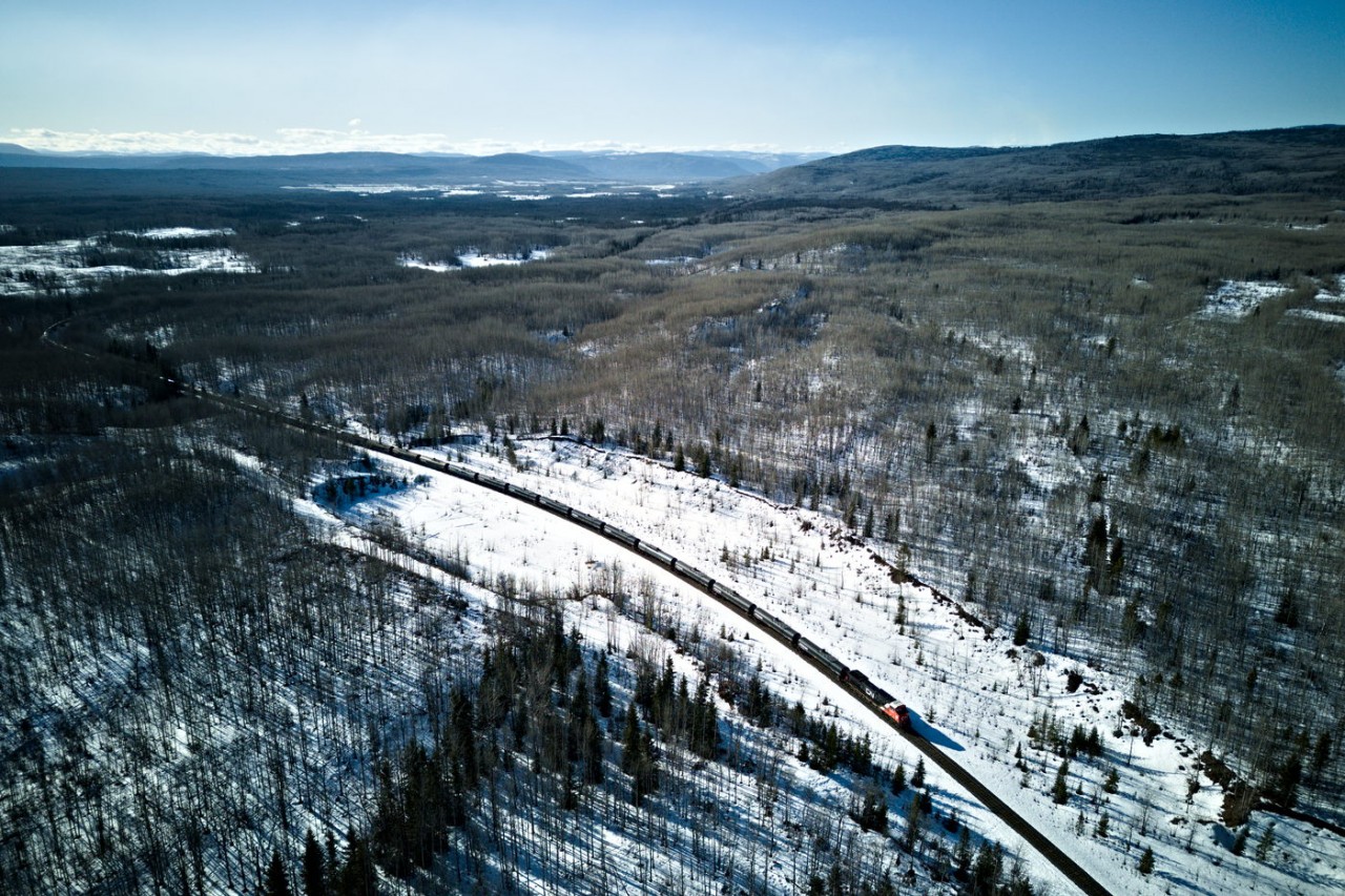 Brand new CN AC44C6M 3434 trails a long LPG train towards Chetwynd, which is almost visible in the valley on the top, center of the photo. Taken with the DJI mini 3.