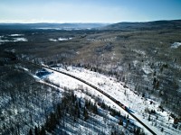 Brand new CN AC44C6M 3434 trails a long LPG train towards Chetwynd, which is almost visible in the valley on the top, center of the photo. Taken with the DJI mini 3.