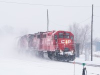 During an inclement snow storm, CP's turn from London heads east into Woodstock with three four-axles up front. They will drop cars for interchange with the Ontario Southland in West Coakley before lifting their cars for London and flipping back west. Points for the GP38AC leading donning clean bank gothic paint.