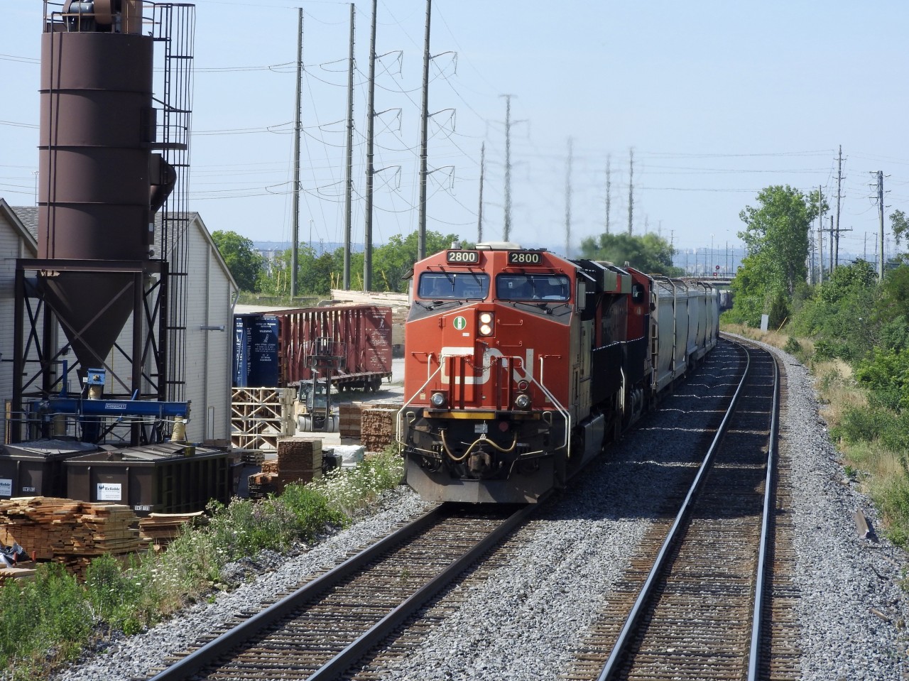CN ES44AC # 2800 entered the Halton Sub at Burlington West and half this train is still on the Oakville Sub.  2800 is heading eastward on the south track as it passes Tamarack Lumber on July 21/2016 as my train 421 heads westward towards Aldershot, where we will make our fist stop before heading to Ft. Erie. Ont