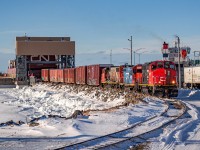 On this Friday afternoon, train 561 (Mont-Joli - Matane turn), departed Mont-Joli light with a set of 3 engines, including a newly brought GTW GP9r, likely the first one to ever roam the Mont-Joli and Matane subdivisions. We can see them here unloading the Georges-Alexandre Lebel railcar ferry with the help of 6 buffer cars and the recently refurbished CFMG caboose, serving as a shoving platform. The rare trio formation of engines would prove helpful, as they ended up pulling a staggering 52 cars out of Matane, most of which were loaded. Apparently, an engine failure caused half of the previous trip to be left out in Matane, which would be the reason behind the massive train.