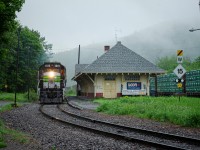 SFG 565's engines crawl past Matapédia station on a foggy Monday morning as they ride on CN's trackage to interchange cars for and from CN 562, before heading to New Richmond. On the right, you can see the cars that they dropped off, and in the background, the cars that they are about to pick up.