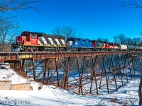 It's been sometime since CN has shown it's face in daylight in St Thomas until recently. What I can only guess is CN 583, is seen crossing the Kettle Creek departing north for London with traffic ex OSR, GIO and further back in the train, truck frames ex Formet. Part of the headend consist is OSR's former RS18u 182- the future CFS 1801.  On Friday, OSR brought the unit down from Salford but had sluffed it in the yard near Formet. Earlier on this day (Sunday) OSR had run an extra to town and part of their chores were to deliver their former unit to the CN for forwarding to the Chemin de fer Sartigan. The Quebec short line operates a section of the former Quebec Central Railway and utilizes MLW locomotives- notably the former BC Rail M420's that OSR owned for a time. 182 is reportedly the first of six to head to Scott, QC.