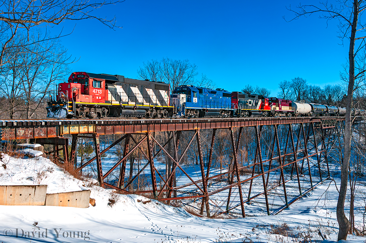 It's been sometime since CN has shown it's face in daylight in St Thomas until recently. What I can only guess is CN 583, is seen crossing the Kettle Creek departing north for London with traffic ex OSR, GIO and further back in the train, truck frames ex Formet. Part of the headend consist is the future CFS 1801. Earlier in the day OSR had run an extra to town and part of their chores were to deliver their former RS18u 182 to the CN for forwarding to the Chemin de fer Sartigan. The Quebec short line operates a section of the former Quebec Central Railway and utilizes MLW locomotives- notably the former BC Rail M420's that OSR owned for a time. 182 is reportedly the first of six to head to Scott, QC.