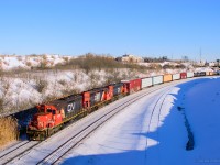 The sun is shining but the wind is chilling.  A pair of CN SD40us with an IC SD40-3 third up spend the day shoving cuts of cars over the hump at Mac Yard.