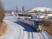 A late VIA 67 in Montreal West yesterday afternoon. In the background is a large hill comprised of snow collected from the city streets.
