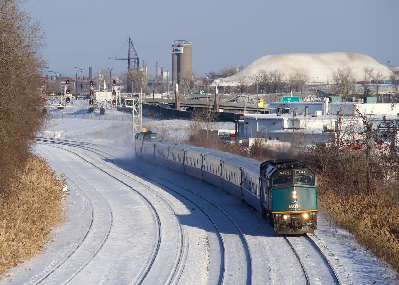 A late VIA 67 in Montreal West yesterday afternoon. In the background is a large hill comprised of snow collected from the city streets.