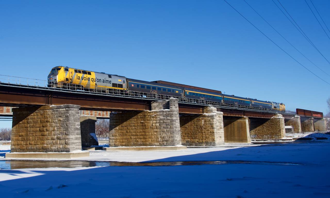 After being delayed by CN 120, VIA 633 crosses the Ottawa River as it approaches Île-Perrot with VIA 918 leading. It is eight minutes behind VIA 63.
