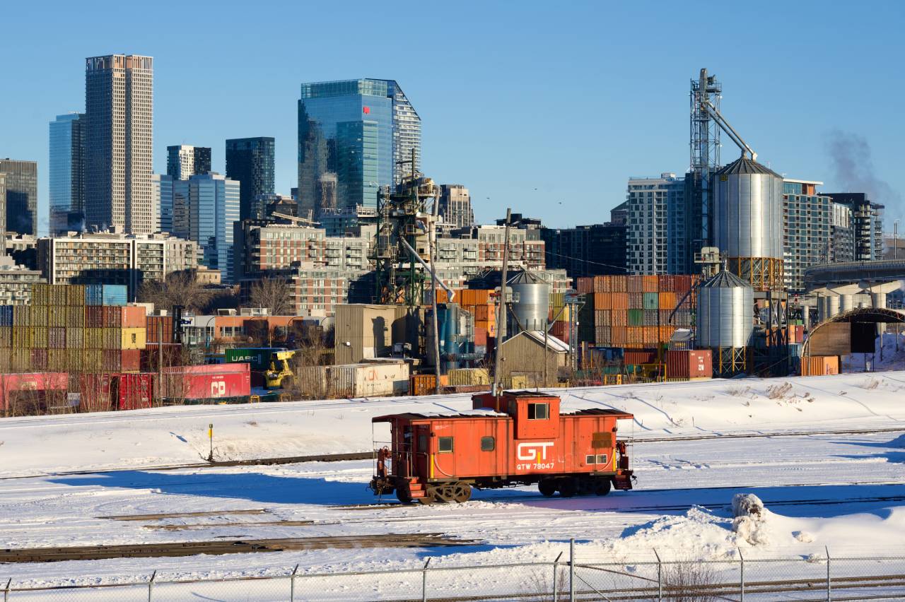 GTW 79047 is stopped at CN's Pointe St-Charles Yard. Soon it will be be tacked on the back of some grain cars and head to a nearby client. It will be used as a shoving platform on the way back.