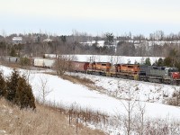 Growing up my family spent a lot of weekends at a campground outside of Acton. Some of my favourite memories are of evenings spent at the campfire listing to distant trains battling the Niagara Escarpment as they headed westward, along with horn echoing through the hillsides. In later years after the camping ended o spent more time exploring CN’s Guelph subdivision around Acton, my day shift ending time often allowed me to chase Goderich Exeters train 431 as it daily battled the Escarpment. This spot for me was a hidden gem often overlooked by a lot of railfans, mainly due to the sun never being in the right location to illuminate everything properly. Cloudy days were preferred here. The sound of the six axle EMD’s fighting the grade was like no other, and they often lost the battle. Unfortunately time rolls on, and CN took back the operations from GEXR  and this end of the subdivision was sold to Metrolinx, with CN becoming a tenant and all freight movements this side of Acton became nocturnal. Today CN still battles the Escarpment but under the cover of darkness. Here GEXR train 431 with my favourite “Tunnel Motor” in the lead is seen heading into Acton under dreary skies. 
