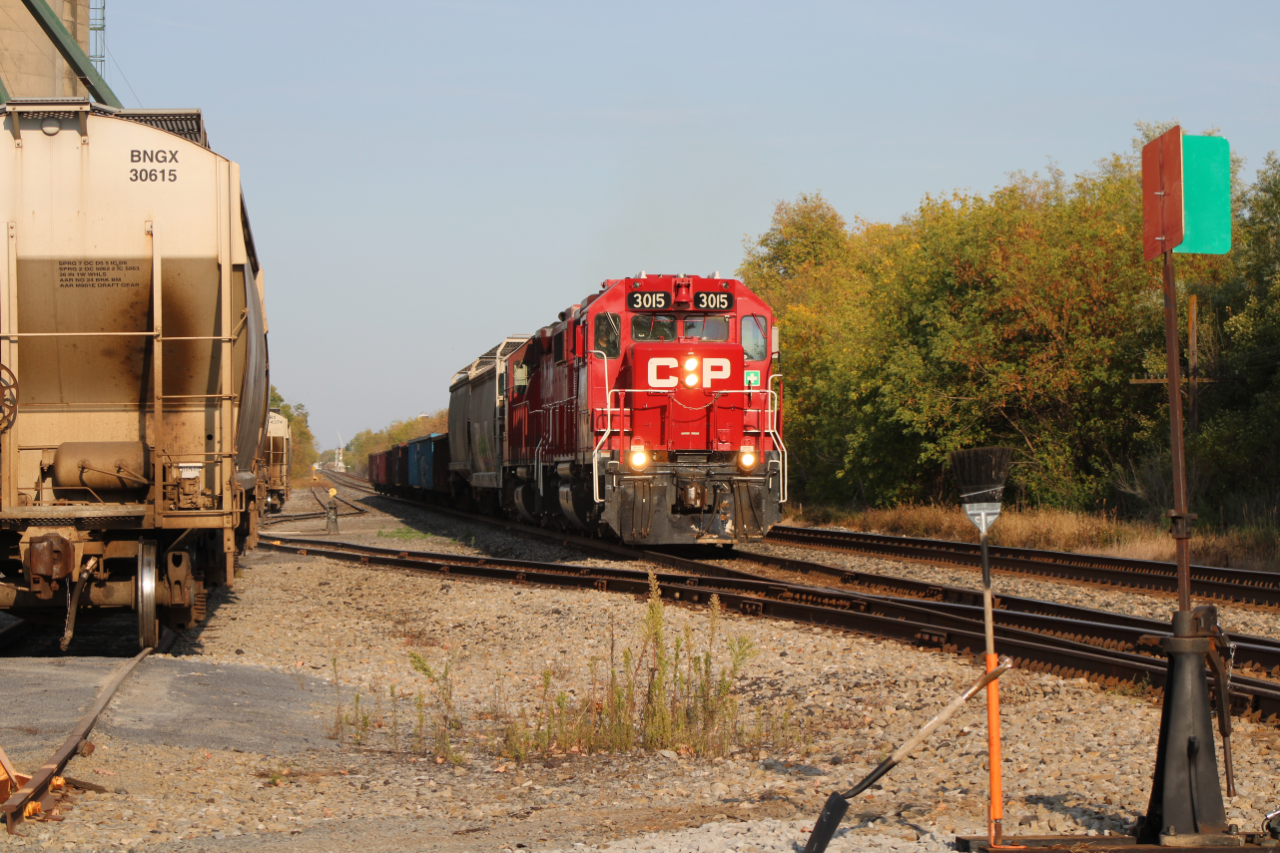 On a hot day at the beginning of fall, CP G62 pulled into Winchester Grain Mill, picked up several railcars, and left. This photo was taken when it was leaving, it pulled out of the crossing slowly heading eastbound to Smiths Falls