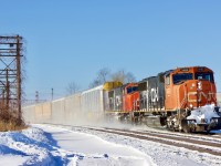 The SD70/75I was the first units I saw arrive brand new on CN’s roster. Seeing them being rebuilt now certainly makes me feel old. I remember seeing them in fresh paint, and now those that have yet to be rebuilt sport paint suffering from many years of service. Hard to believe I would be chasing these units in their original paint these days as they await their turn for a rebuild and AC conversion. After catching the train at Bowmanville my son and I wanted a decent side shot so we  headed for Coubourg to catch the pair kicking up snow on a -30 windchill day passing the VIA station. It appears 5682 has received a replacement snow plow possibly from a SD40 as the old white stripes are showing through the grime. 