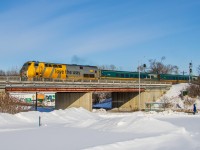 An LRC set in Ottawa? Leaving in daylight, and the sun is actually out?<br><br>
Unlike some equipment... there was no question whether this veteran consist would have any difficulty with the -11°C air temperature this morning. At exactly 0935, the spooled-up prime mover in P42DC 919 was audible from my snowbank perch, as VIA #43 departed right on time. A moment later it had completed the "hard left" leaving Ottawa station westbound, with LRC clubs 3473 and 3471, and coaches 3361, 3324, and 3353. This bridge carries the Beachburg Subdivision over a connection to the bus-only Transitway, used by OC Transpo buses accessing Hurdman station.<br><br>
Normal can become boring until it suddenly isn't normal anymore. A view just like this could be anytime in the last decade or so. Change the paint (or wraps) and this could be anytime in the last 25 years. With a different locomotive (and yes, searchlight signals), this could be 40 years ago. Today, Ottawa sees one LRC consist per day, maybe. It is usually a late evening arrival from Toronto, turned and sent back early the next morning. (This one was #54 the evening before.) With few decent accessible locations in the city, and awkward light angles for most of the day, it's getting very hard to catch these.<br><br>
The LRC fleet is dropping off fast. If you are near the corridor, go shoot these while you can. P42s too - they may not be popular now, but the sentiment will change later. When F40s first proliferated across North America, we begrudged them for what they replaced. Thanks to VIA's rebuilds, we still have their familiar presence up here, but Amtrak fans now wax nostalgic for them. The GE Genesis line subsequently became ubiquitous passenger power, and soon they will be gone too. Don't take them for granted. I may have a few more chances to try this, but pretty soon it will be unrepeatable.