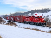 CPKC 01H-08 rolls past the Gwynne Ski Hill and digs in for the climb out of the Battle River Valley. 